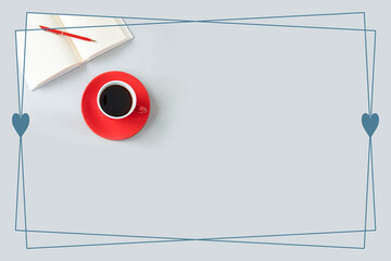 灰色の背景と赤いペンとコーヒーと見開きの本のハート・フレーム	

