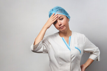 Exhausted female doctor having headache