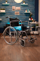 Fototapeta premium Empty living room in apartment with wheelchair on floor for disabled people. Nobody in indoors space decorated with modern furniture and walking support. Cozy interior with decorations