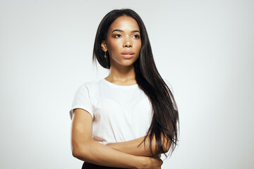 pretty woman of african appearance in t-shirt fashionable hairstyle light background