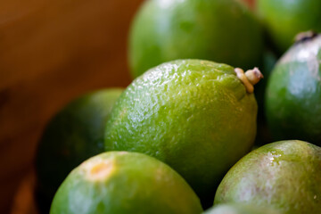 close up fresh lime, lemone in studio light on black stone plate in the kitchen.