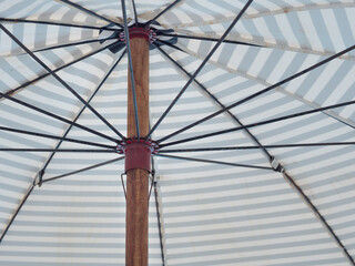 Under a large umbrella for relax during the summer holidays. Large umbrella protection from the sun or rain.