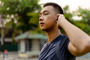 Sports and recreation concept a male adolescent doing warm-up movements as raising his body temperature and increasing blood flow to his muscles