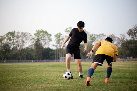 Sports and recreation concept two male soccer players attending regular practice sessions and memorizing attack and defense patterns