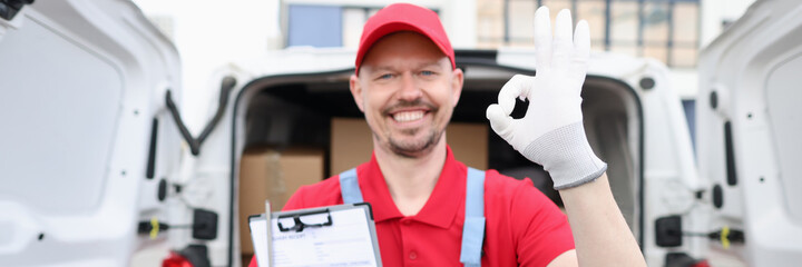 Male courier holding delivery receipt and showing okay gesture closeup
