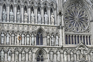 Detail Gothic roman catholic Nidaros cathedral in Trondheim with statues on the facade