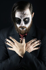 Dark creepy vampire in elegant costume. Halloween costume and makeup. Spooky ghost