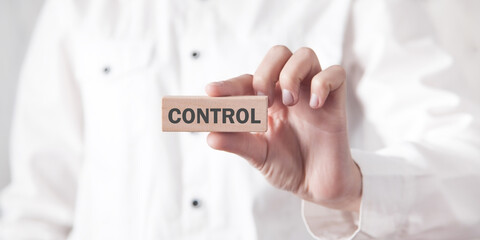 Human showing Control word on wooden block.