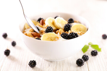 bowl of muesli, milk and fresh fruits