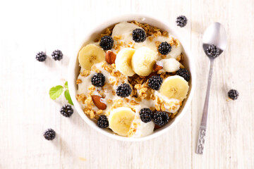 bowl of muesli, milk and fresh fruits