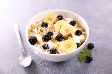 bowl of muesli, milk and fresh fruits