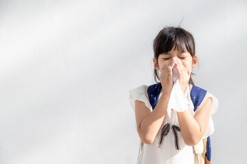 Asian child girl sick with sneezing on the nose and cold cough on tissue paper because weak or...