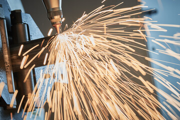 Fiber laser tube cutting machine. metal pipe cutting with sparks
