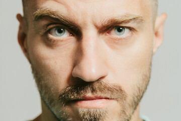 Angry unhappy serious man with disapproving expression on face. Close up portrait. Isolated white background. Negative emotion