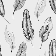 Seamless pattern of bird feathers, hand-drawn on a beige background in boho style.