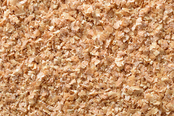 food background of uncooked wheat bran, top view