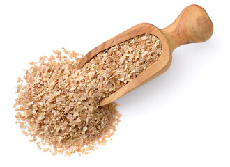 uncooked wheat bran in the wooden scoop, isolated on the white background, top view