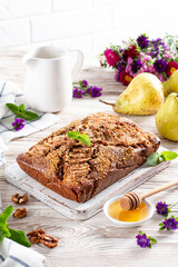Homemade Chocolate Pear Cake. Ripened pears in a wooden background