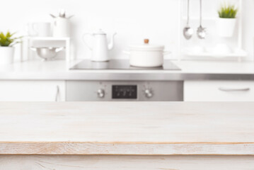 Empty wooden table with blur kitchen background and copy space
