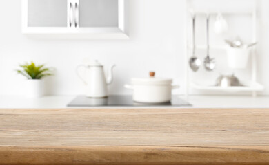 Blurred view of kitchen interior on background and wooden table