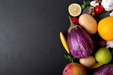 Composition of Vegetables, fruits and berries purple on a black background. Healthy food. Organic food