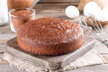Photo of delicious chocolate sponge cake on table