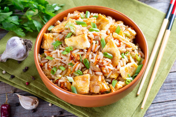Fried rice with vegetables and fried eggs on a table - Chinese cuisine