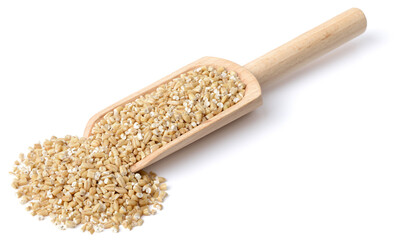 raw steel cut oats in the wooden scoop, isolated on the white background