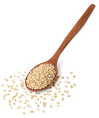 raw steel cut oats in the wooden spoon, isolated on the white background