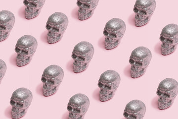 Sparkling skulls scary minimal pattern arrangement. Baby pink creepy background