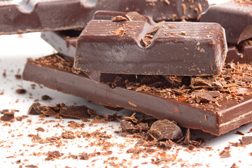 Chocolate pieces on white background close-up photo