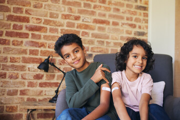 Two brothers with plasters on their arms 