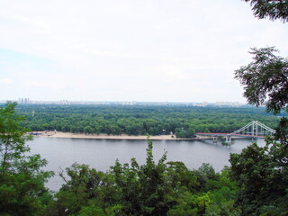 Fototapeta premium Unsurpassed landscape of the Dnieper surrounded by dense greenery almost in the center of the green city.