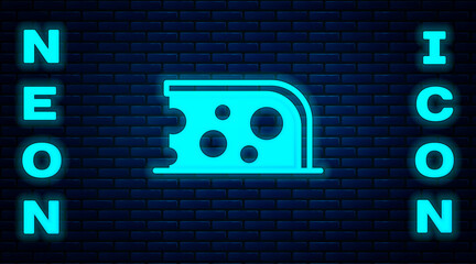 Glowing neon Cheese icon isolated on brick wall background. Vector