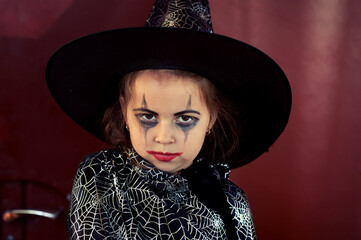 Portrait of a little girl in a festive costume for Halloween