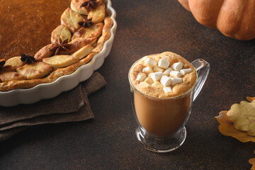 Warming coffee and homemade pumpkin pie with for autumn cozy day. Close up.