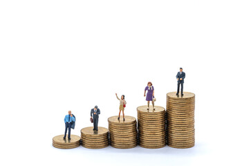 Business, Money Investment and Planning Concept. Group of Businessman and businesswoman miniature figure people figure standing on stack of gold coins on white background.