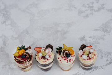 Set of beautiful delicious trifl close - up on the background. Dessert and sweets