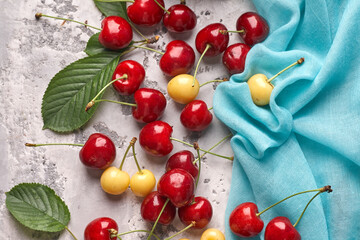 Obraz na płótnie Canvas Ripe red and yellow cherries on gray background