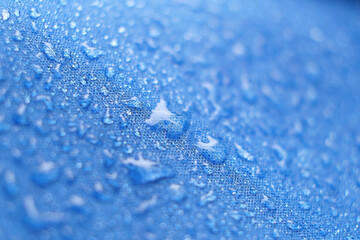 Water Proof Textile block water to pass through to stay dry. water beading on fabric. soft focus,...