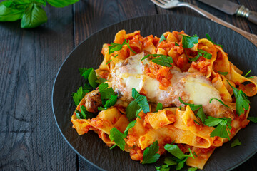 Baked chicken breast with mozzarella cheese,  pasta and tomato sauce