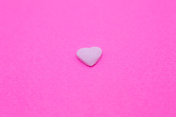 Pink heart on pink background. Saint Valentine's day concept. Love and romantic photo. Postcard for holiday. Beautiful warm wallpaper with love. Soft focus. Copy space.