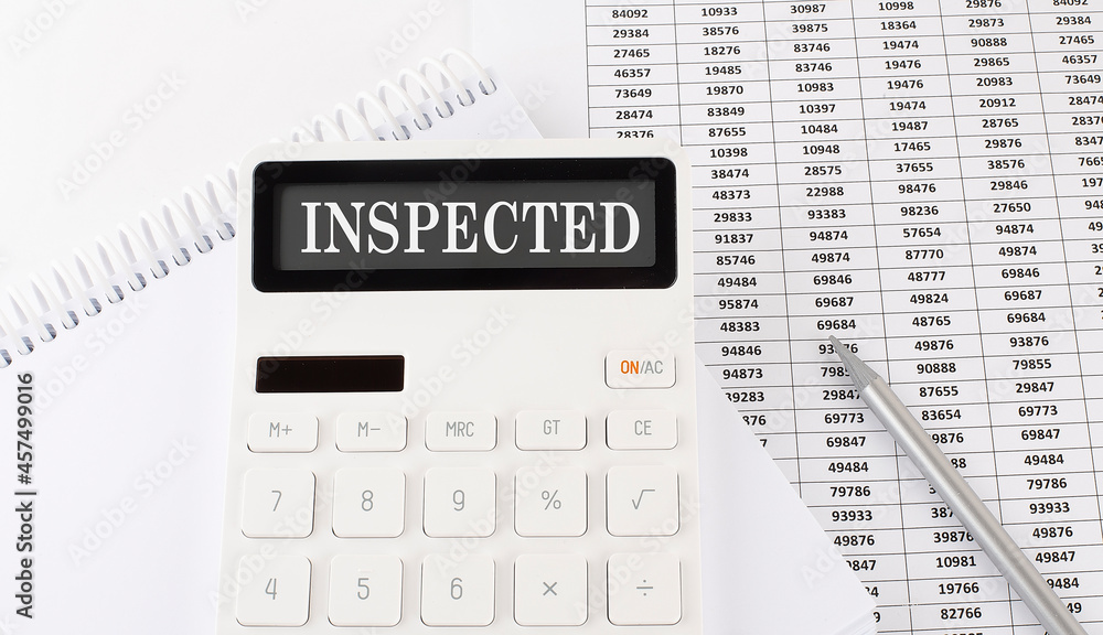 Poster calculator with text inspected on the notebook . business, finance conceptual.