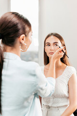 Make-up master does makeup for a client