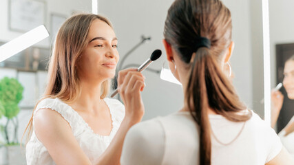 Obraz na płótnie Canvas Make-up master does makeup for a client