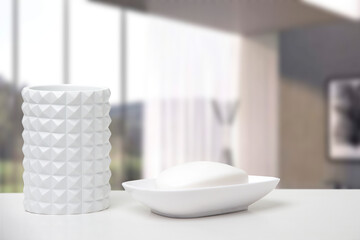 
A glass for dental bills and a soap dish with soap on a white table in a bathroom