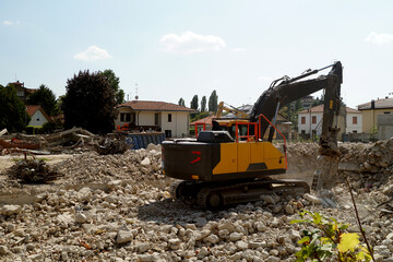 Bulldozer demolisce area induztriale dismessa, demolizione capannone industriale, ruspa demolisce edifico dismesso