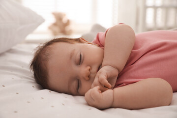 Fototapeta na wymiar Cute little baby sleeping on bed at home, closeup