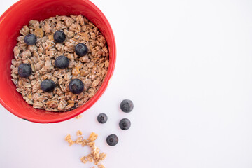 red bowl with cereals and blueberries