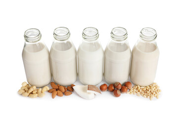 Vegan milk and different nuts on white background